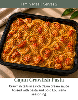 Cajun crawfish pasta in a black tray, creamy orange sauce with crawfish, labeled family meal serves 2
