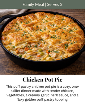 A golden, flaky puff pastry Chicken Pot Pie in a black skillet, topped with herbs, with 
