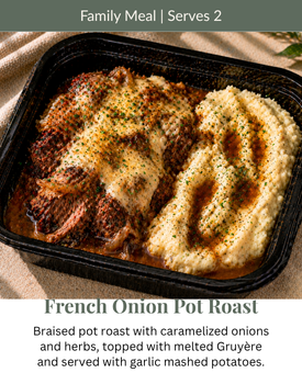 French onion pot roast in a black tray, topped with melted Gruyère and caramelized onions, serves 2