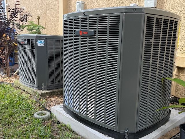 A log cabin has a large deck with a table and chairs on it.