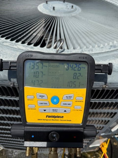 A log cabin has a large deck with a table and chairs on it.