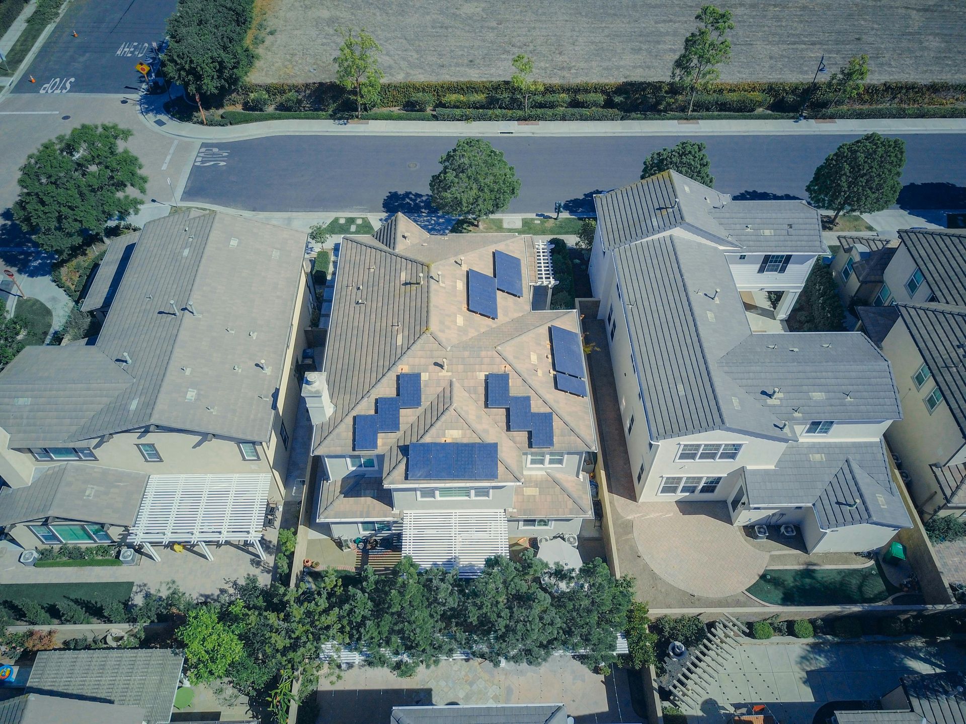 An aerial view of a residential area with solar panels on the roofs of houses.