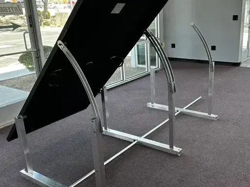 A solar panel is sitting on a metal stand in a room.