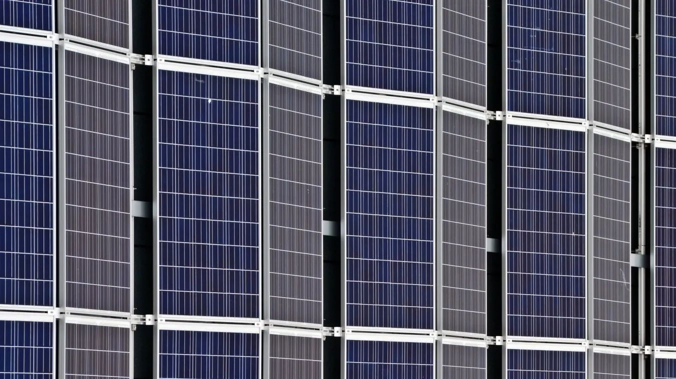 A close up of a row of solar panels on a building