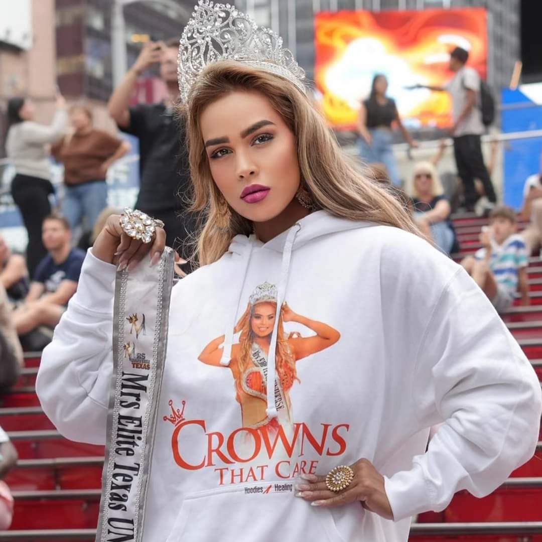 A woman wearing a white crowns that care sweatshirt
