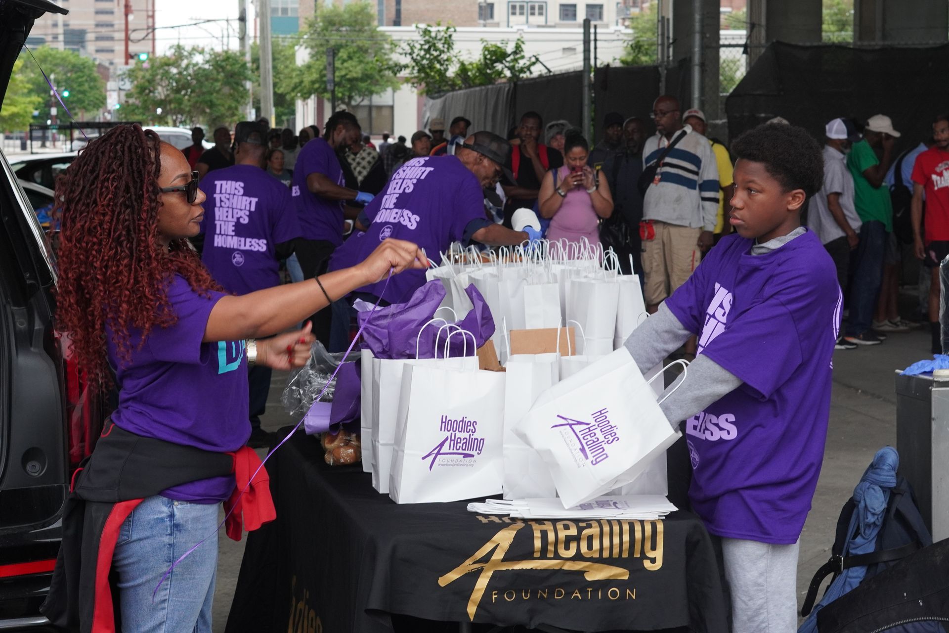 A group of people standing around a table that says reality