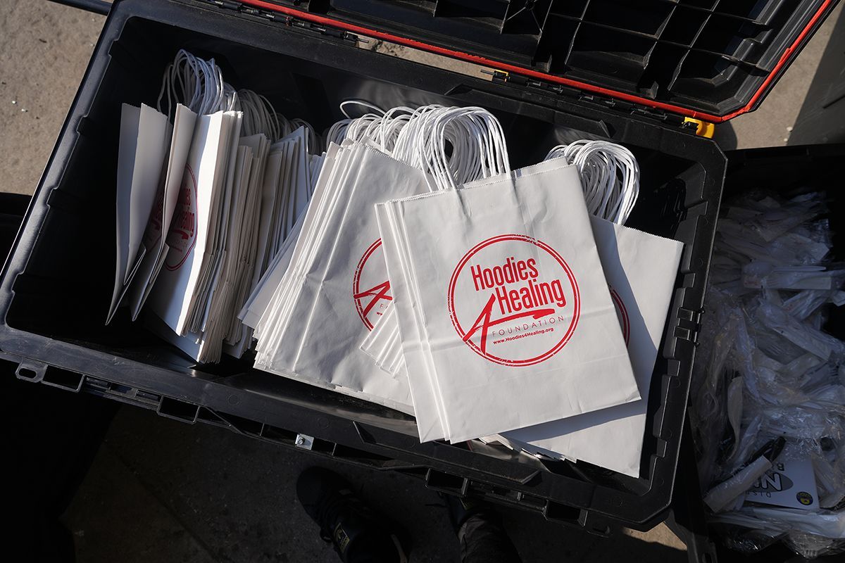 A black box filled with a bunch of napkins with a red logo that says pirates paradise