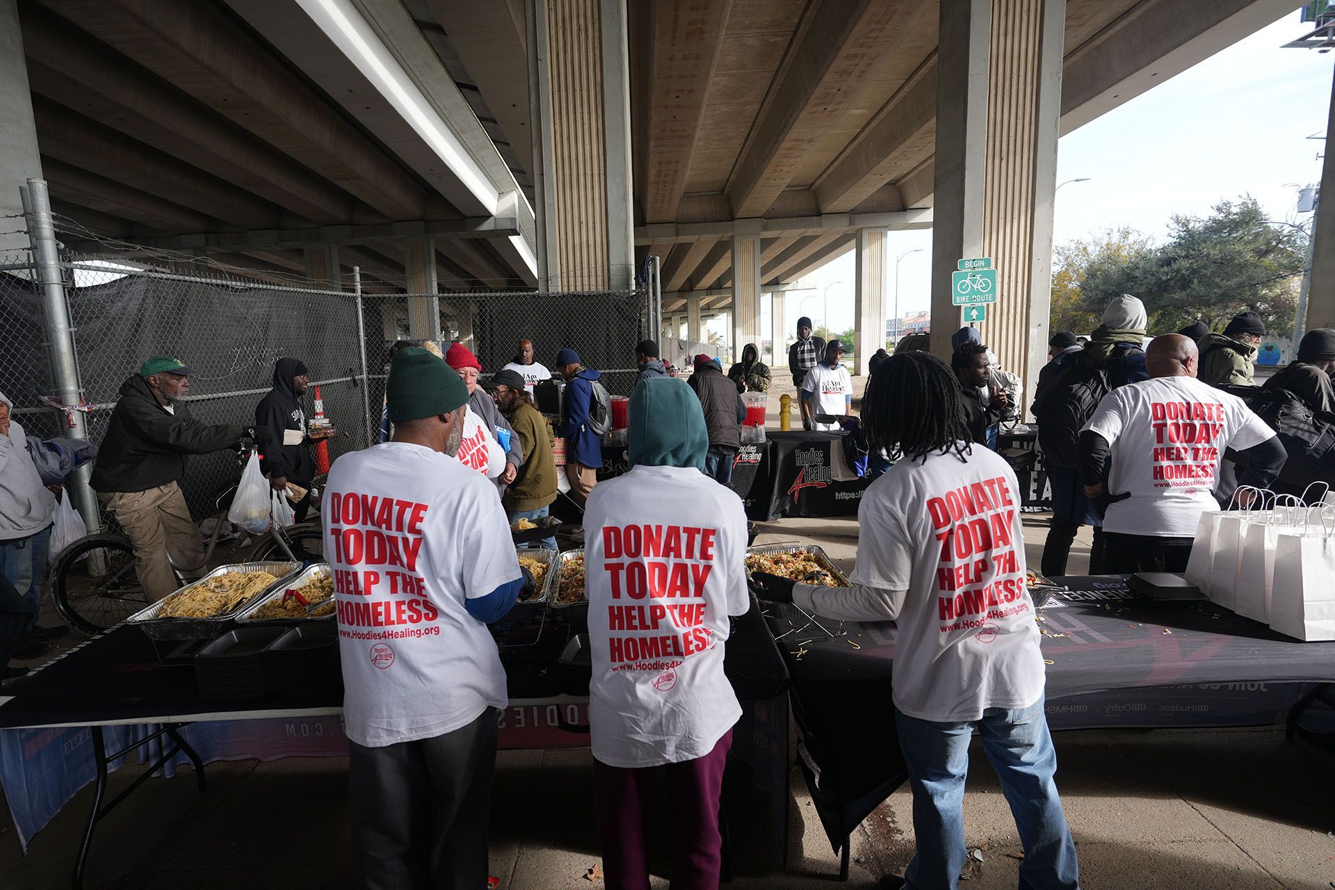 A group of people wearing shirts that say donate today
