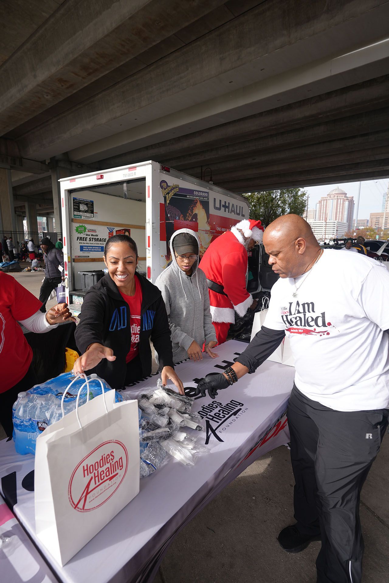 A man wearing a shirt that says i 'm grateful is standing at a table