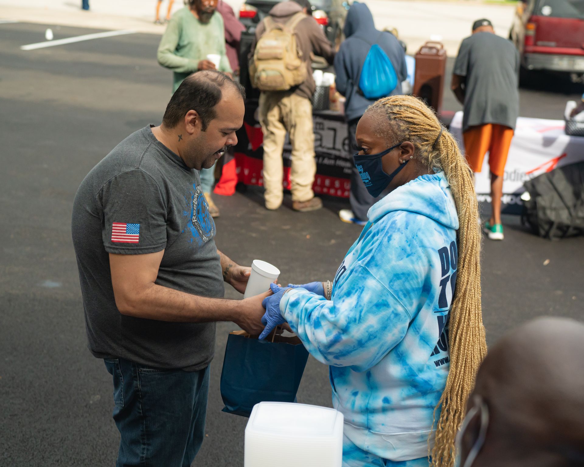 A man and a woman are standing next to each other on a street.