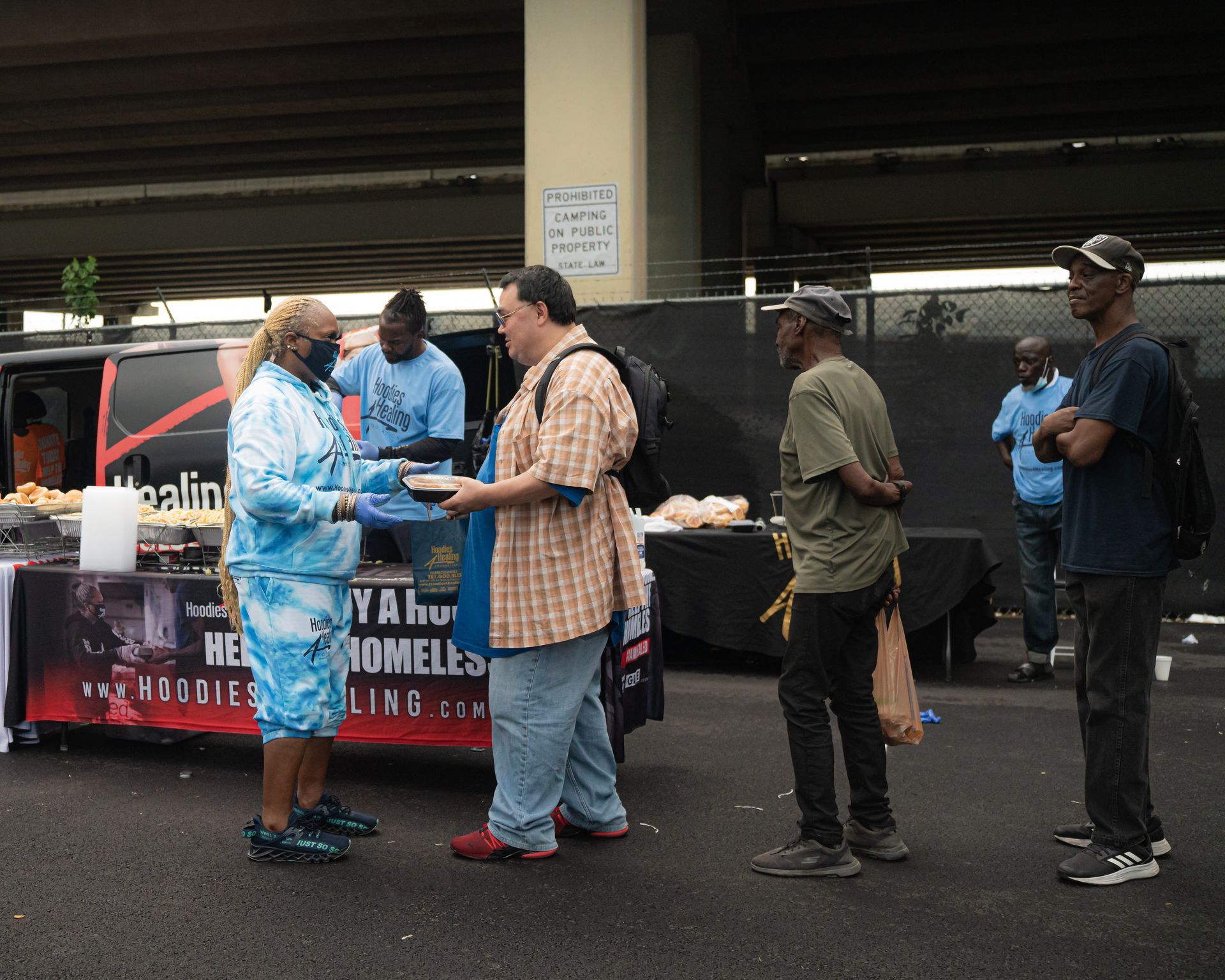 A group of people are standing in front of a food truck.