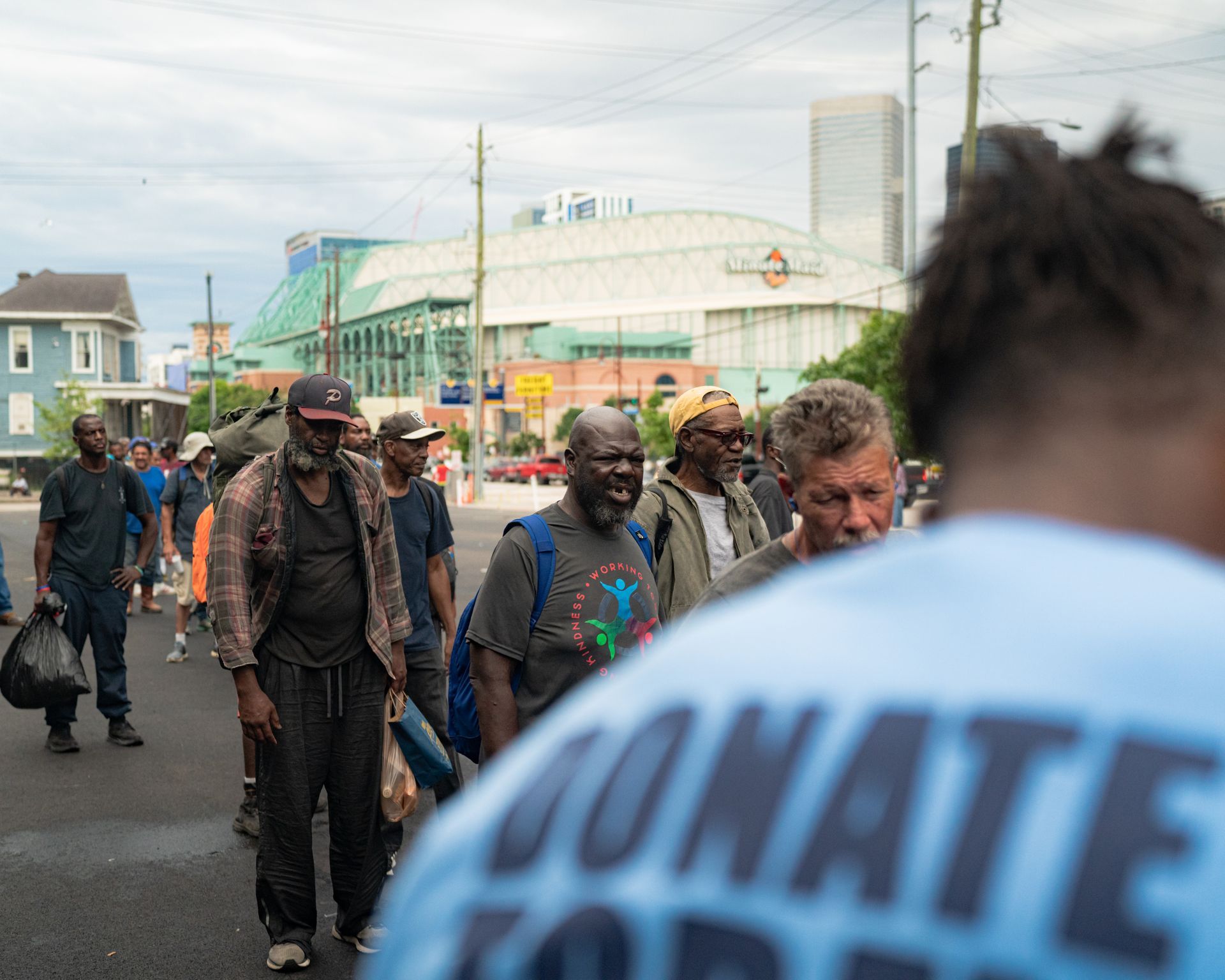 A man wearing a blue shirt that says donate on it