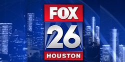 The fox 26 houston logo is on a blue background with a city skyline in the background.