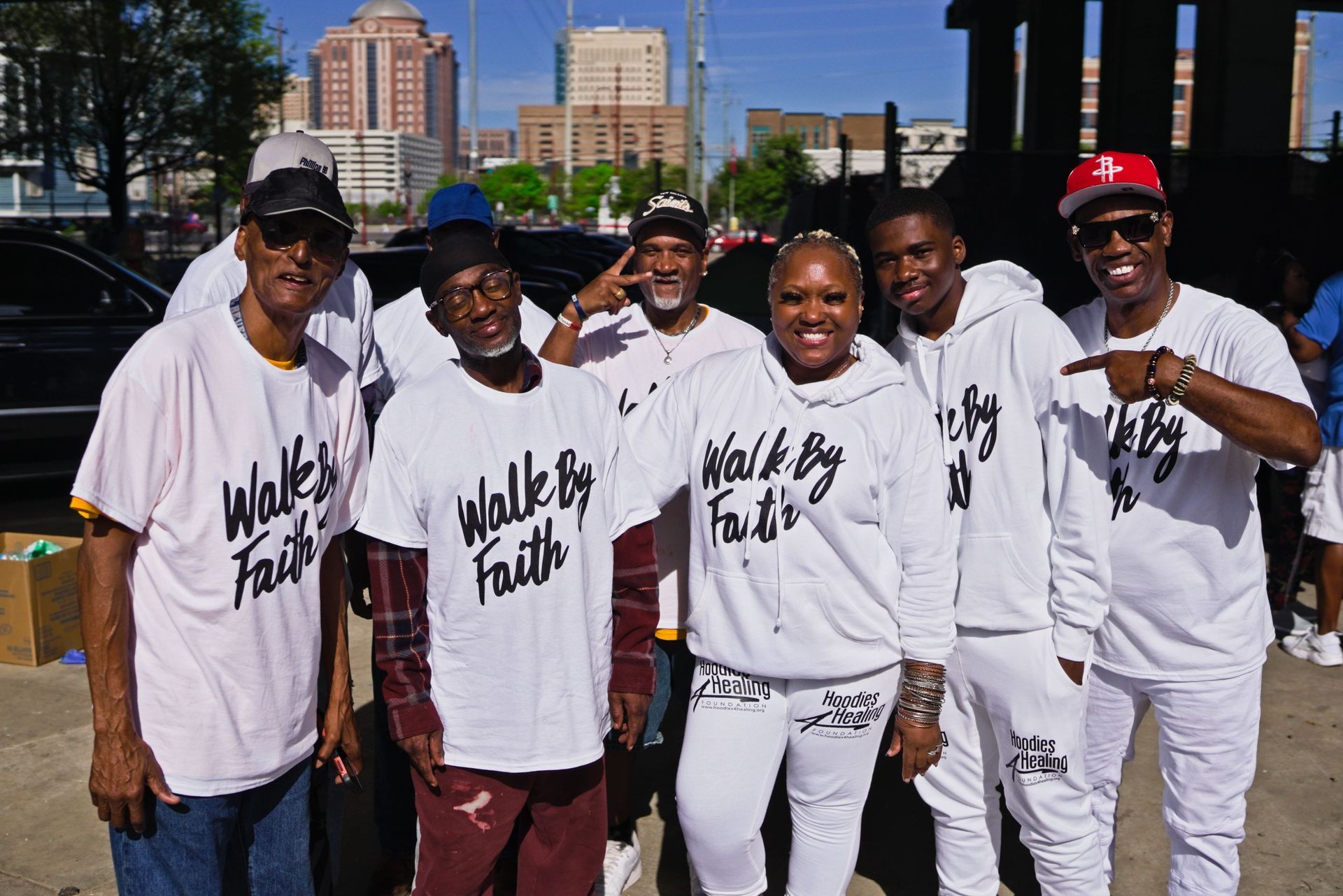 A group of people wearing white shirts that say walk by faith