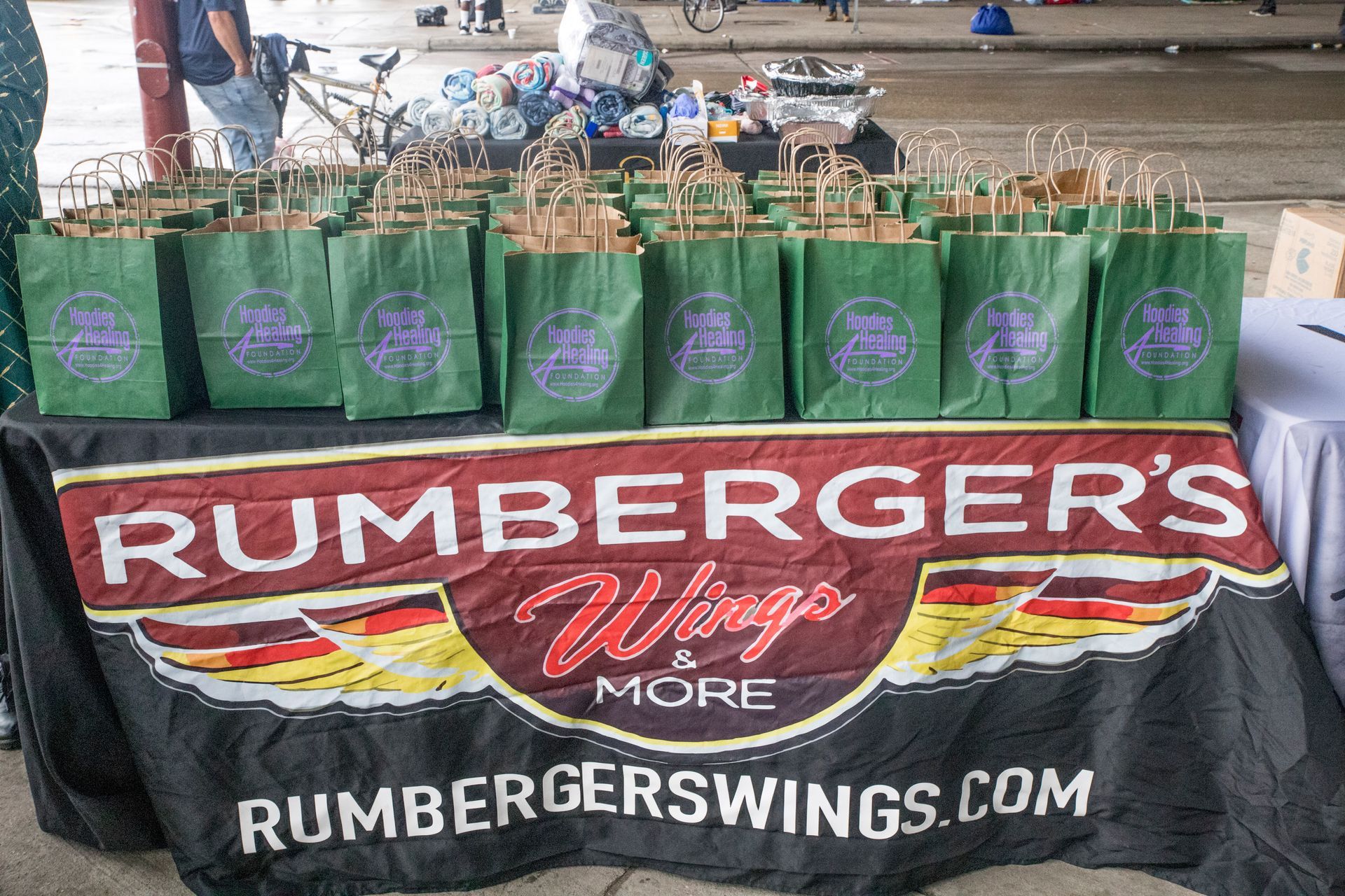 A table with rumberger 's wings more bags on it