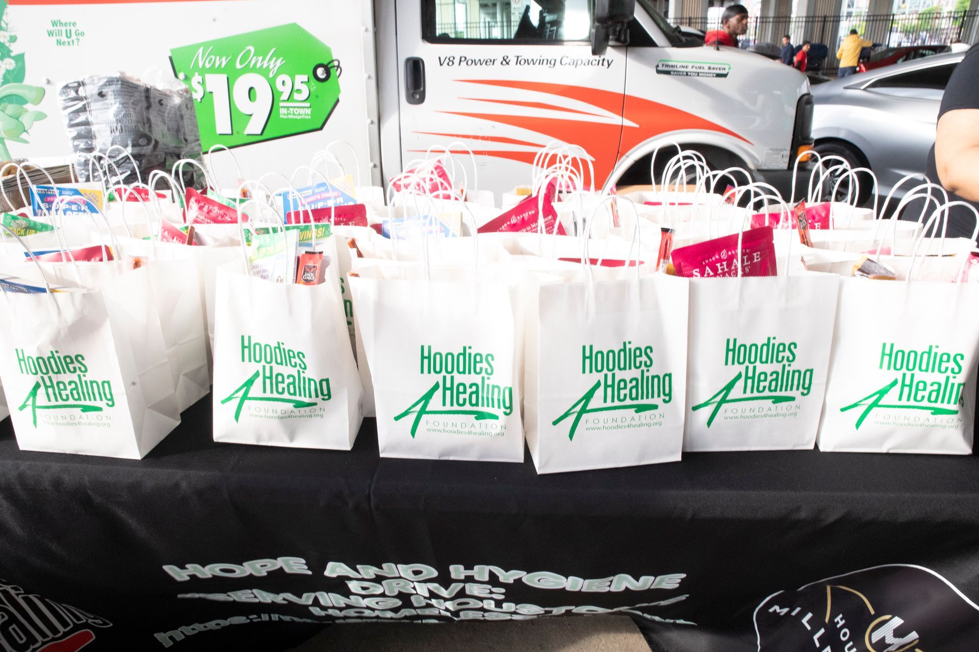 A table with bags on it that say hoodies healing