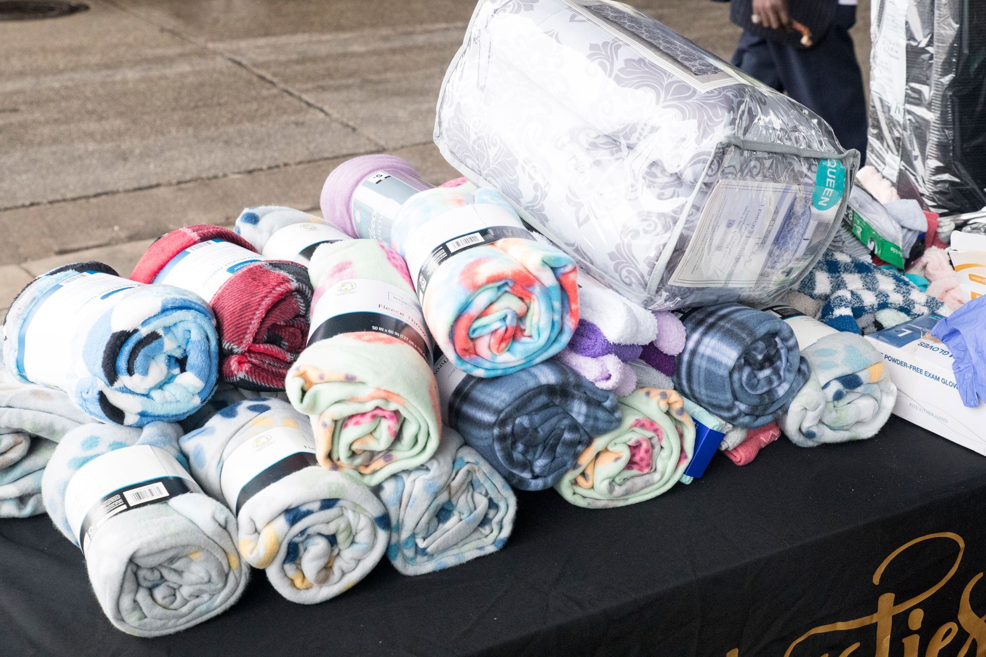 A bunch of blankets are rolled up on a table