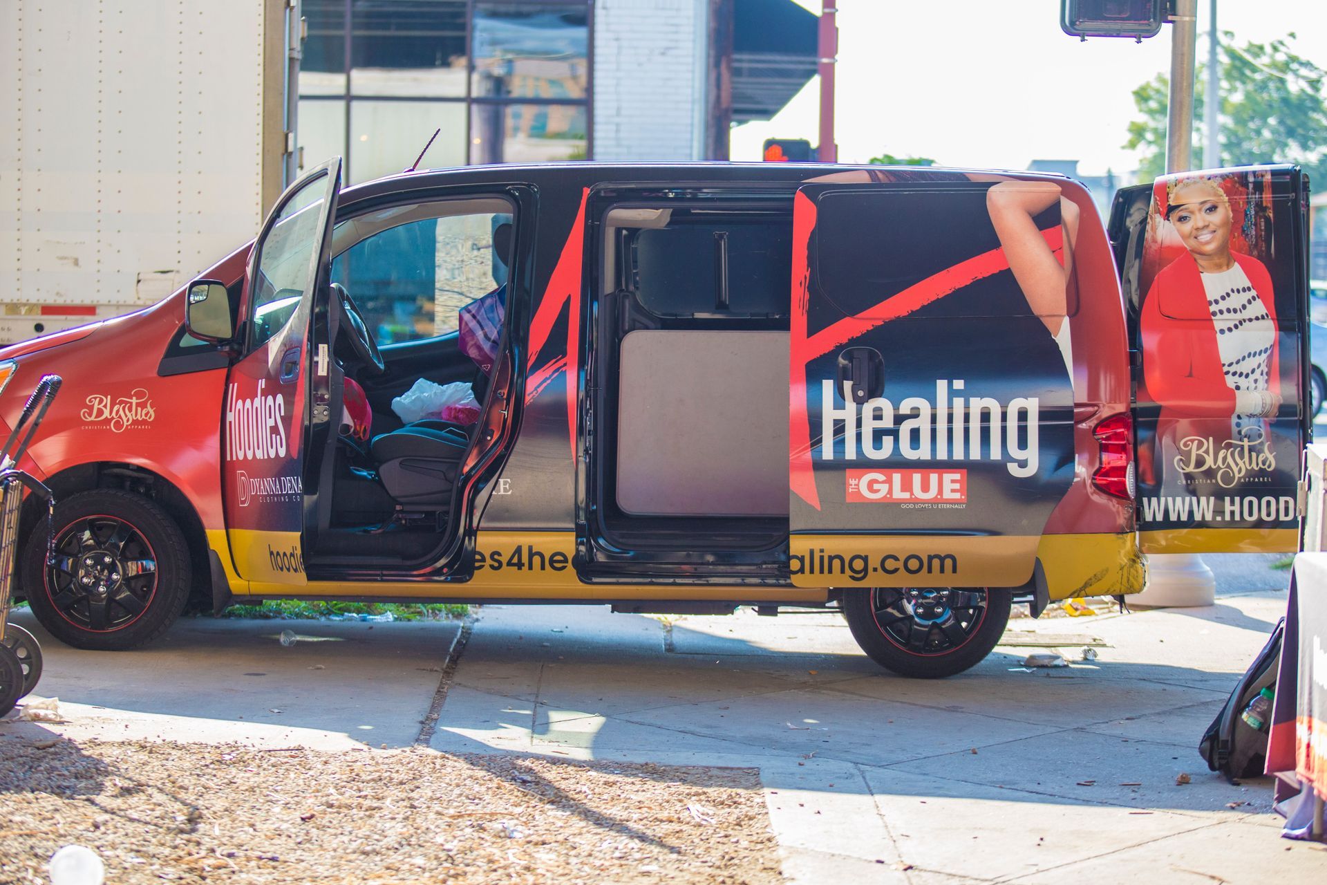 A healing glue van is parked on the side of the road