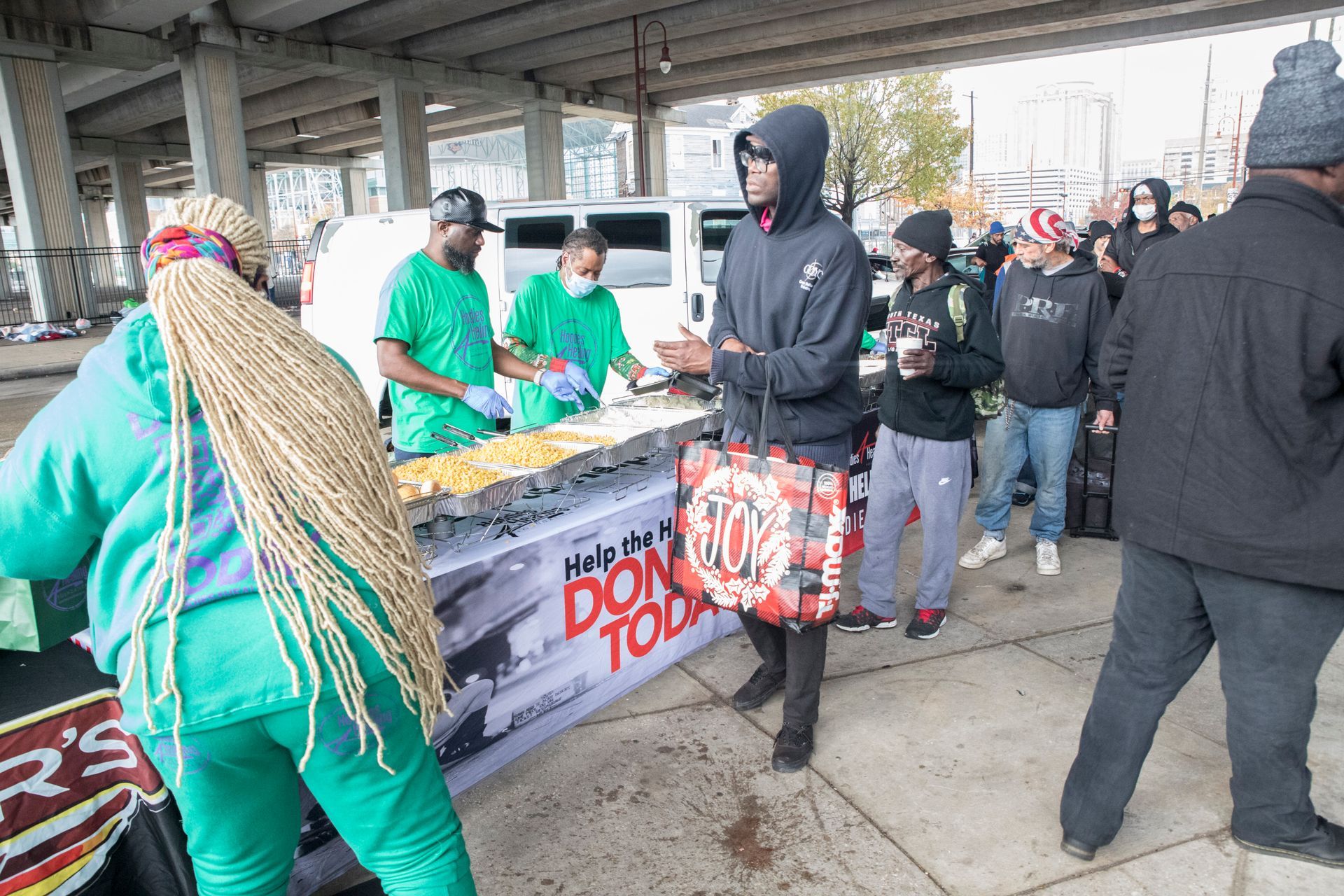 A group of people standing around a table that says don 't touch