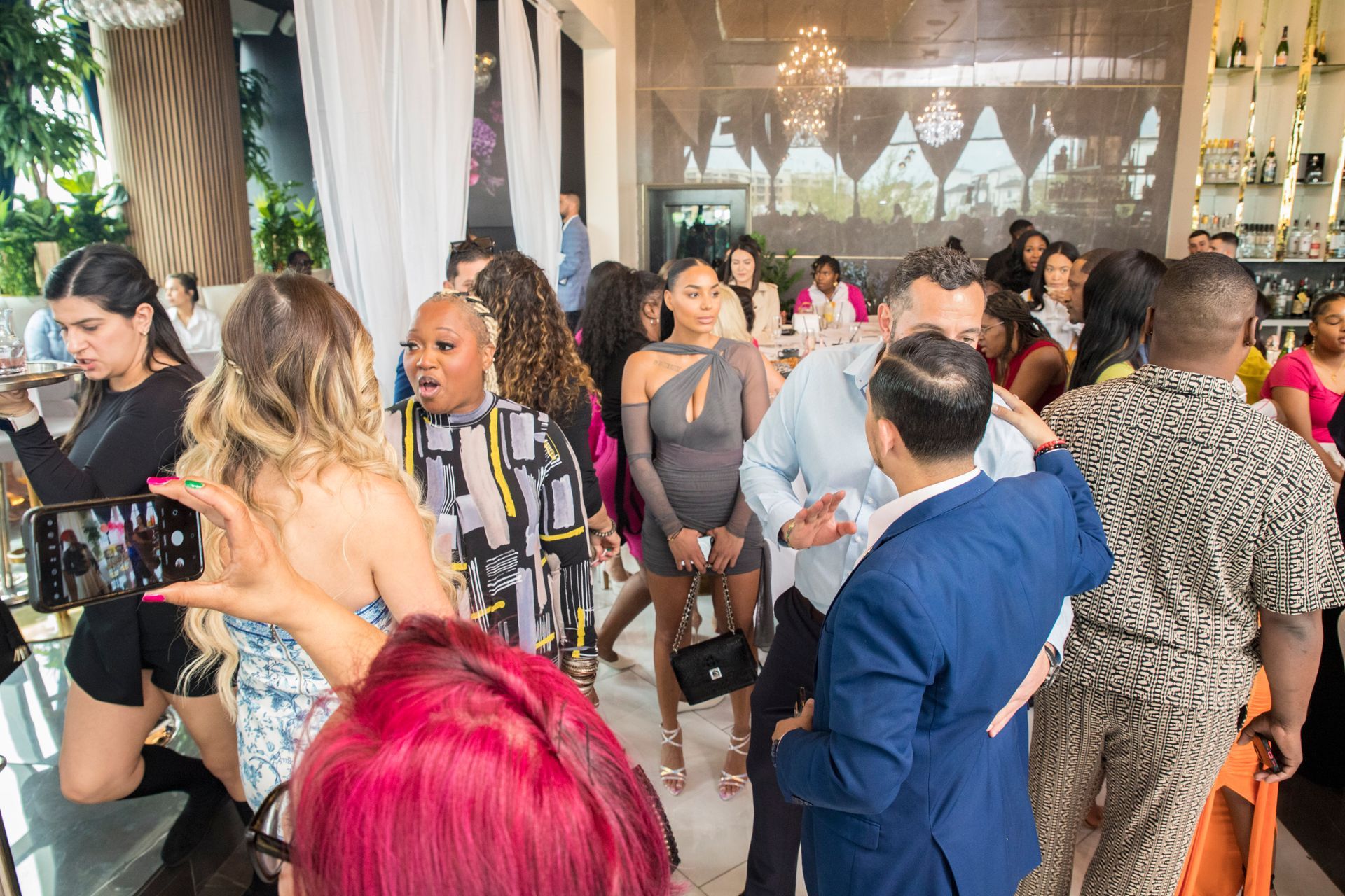 A group of people are dancing in a room at a party.