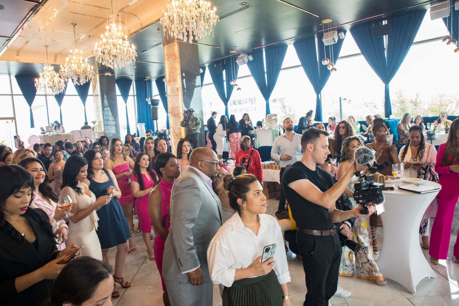 A large group of people are standing in a room.