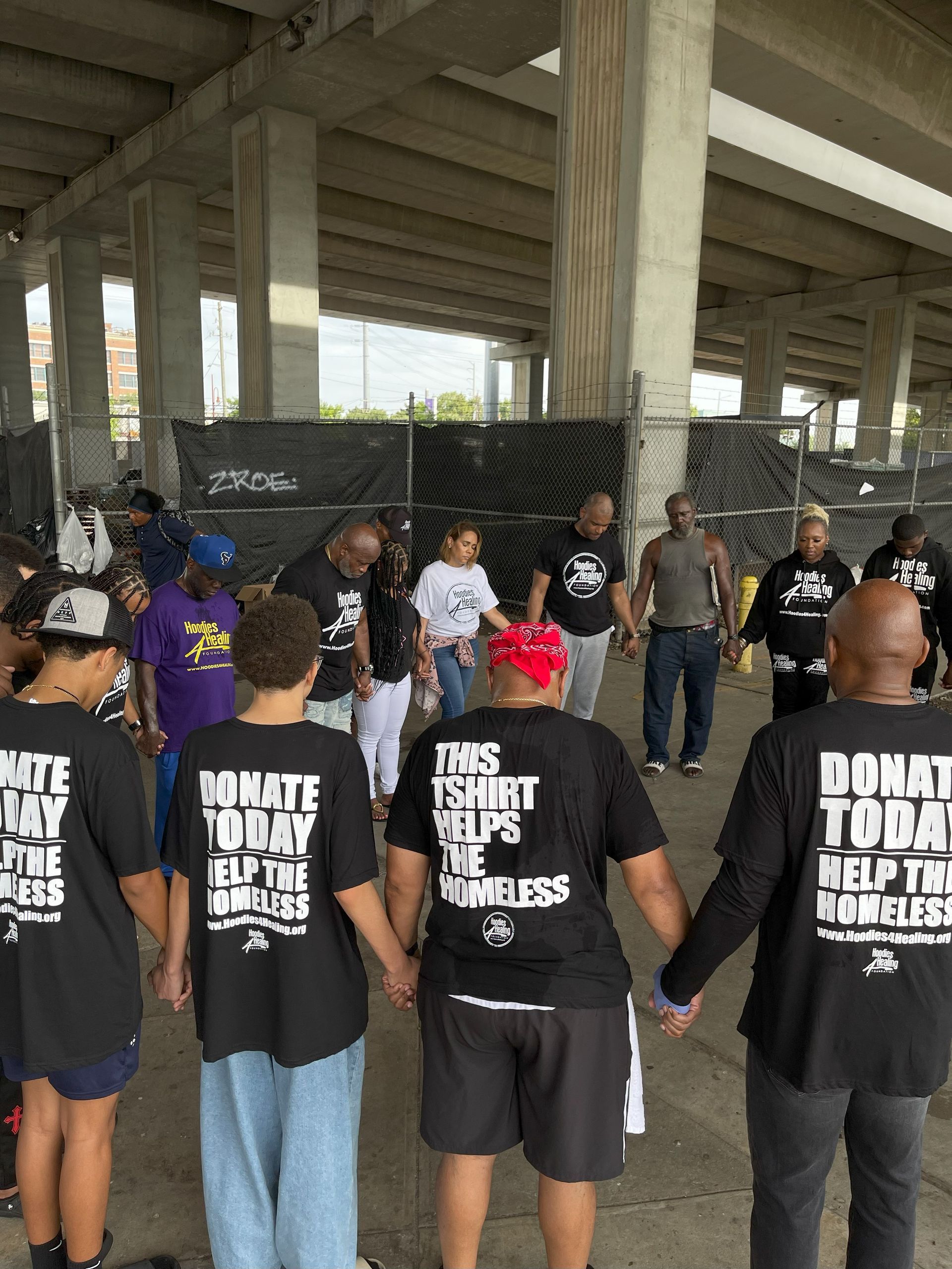A group of people wearing black shirts that say donate today