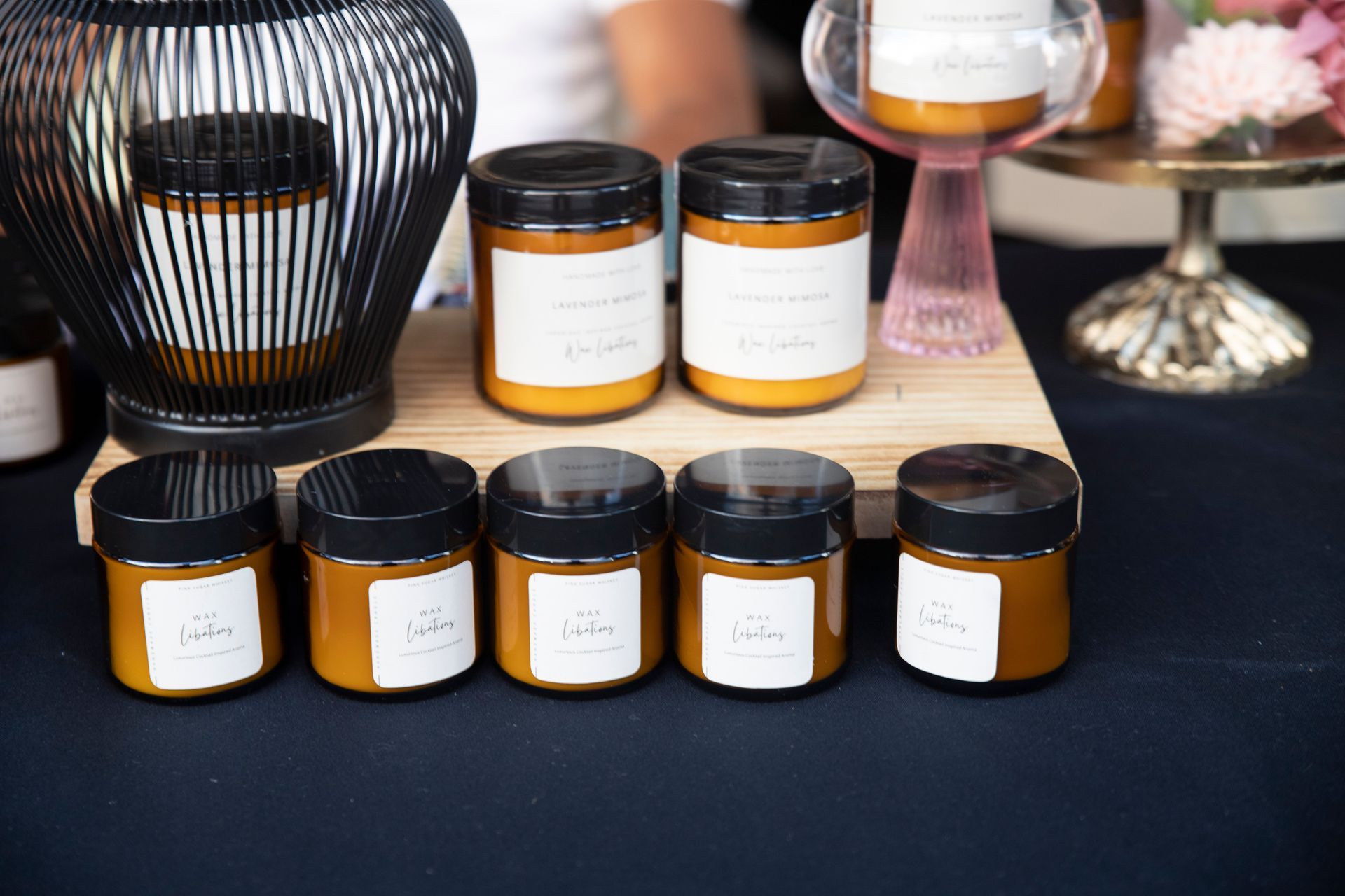 A row of jars sitting on top of a wooden table.