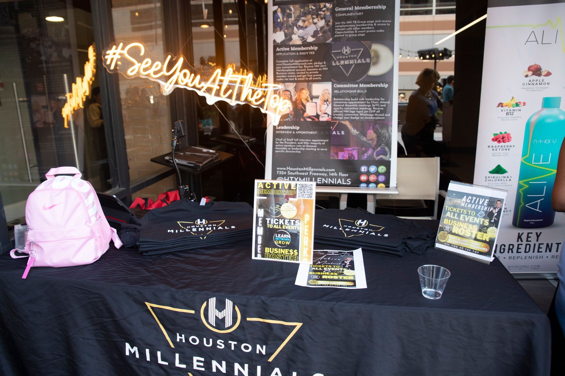 A table with a sign that says see you at the houston millennials