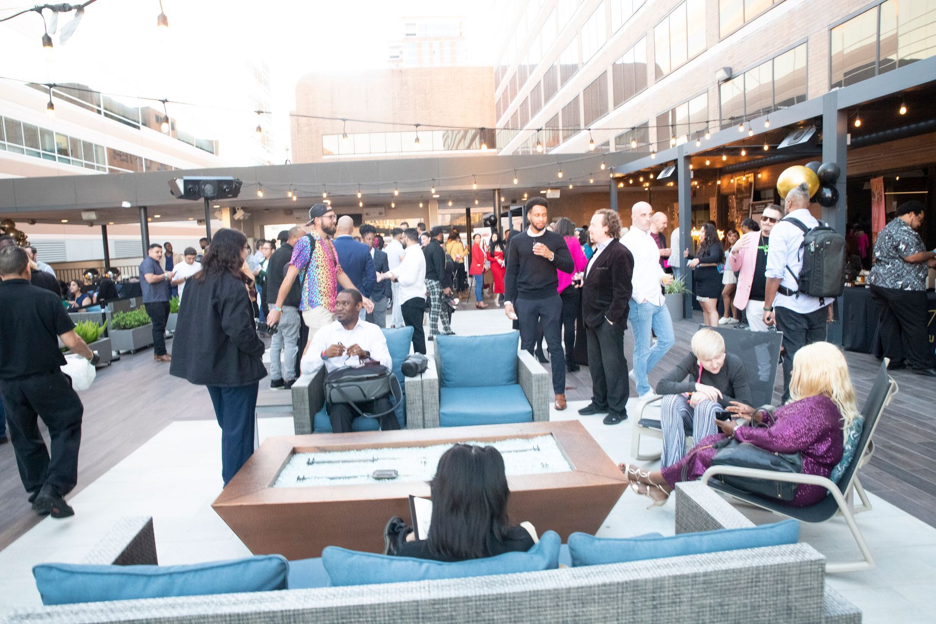 A group of people are sitting on a couch in a room.