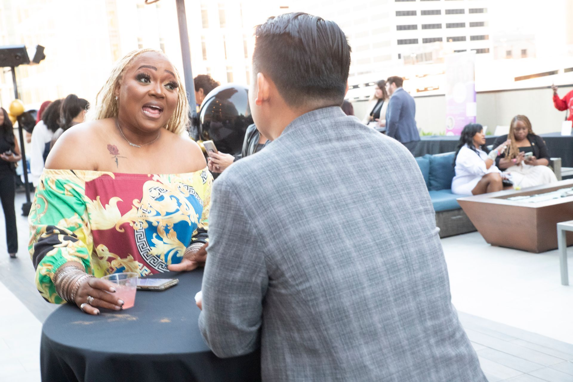 A man and a woman are sitting at a table talking to each other.