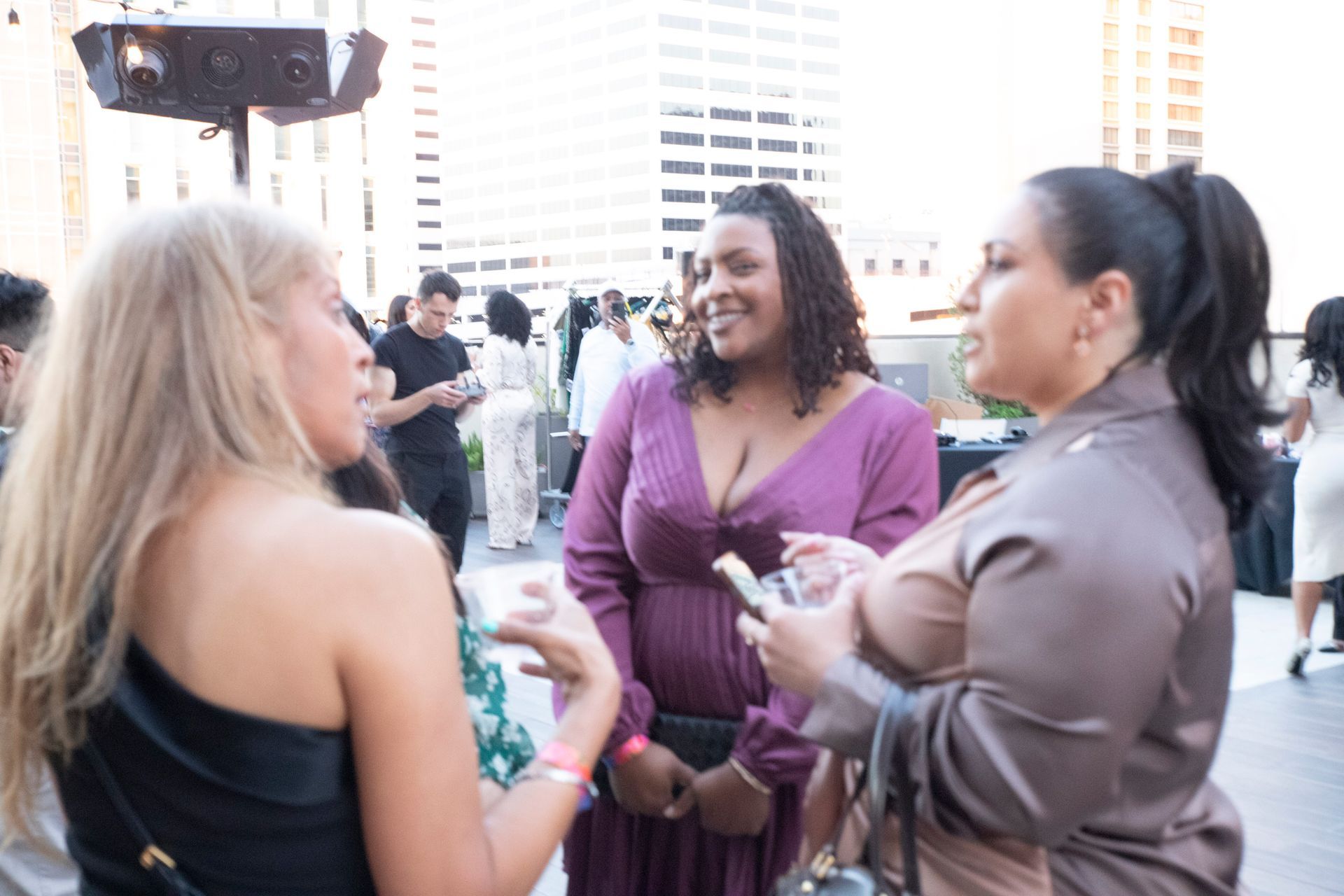 A group of women are standing next to each other and talking.