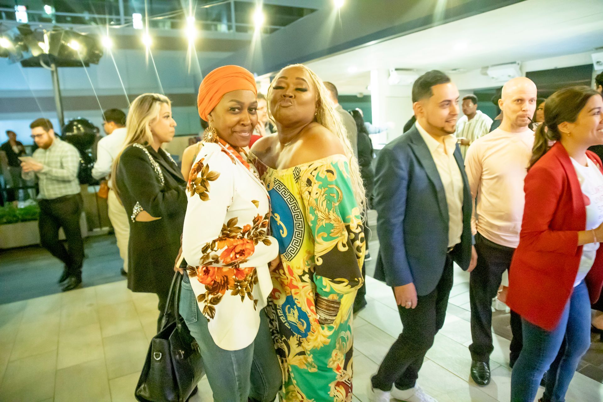 A group of people are standing next to each other in a room.