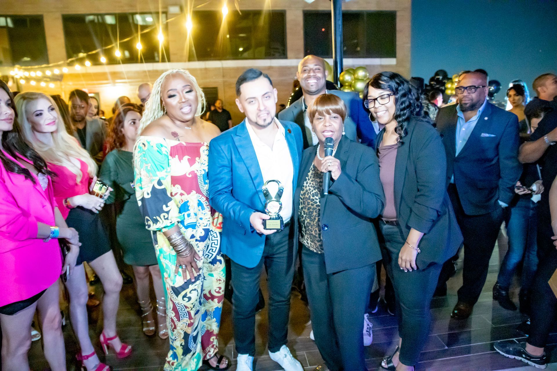 A group of people are posing for a picture at a party.