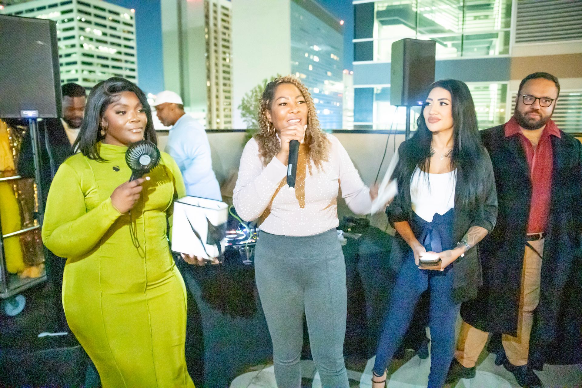 A group of women are standing next to each other holding microphones.