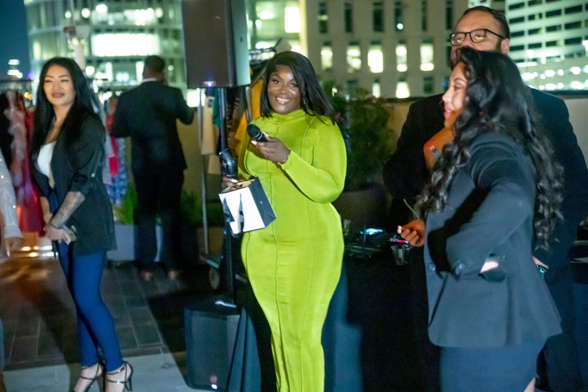 A group of people are standing next to each other at a party.