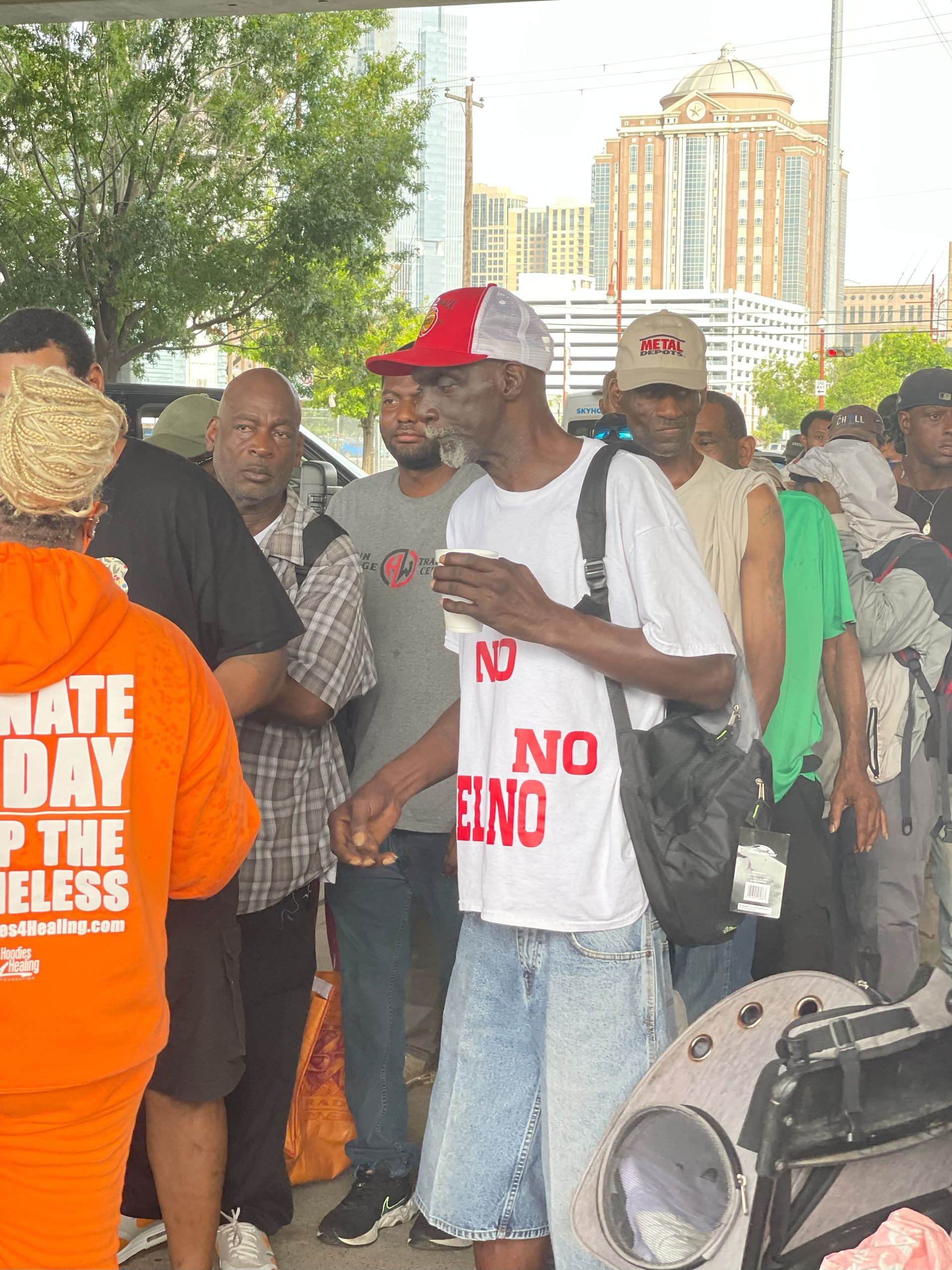 A man wearing a white shirt that says no one on it