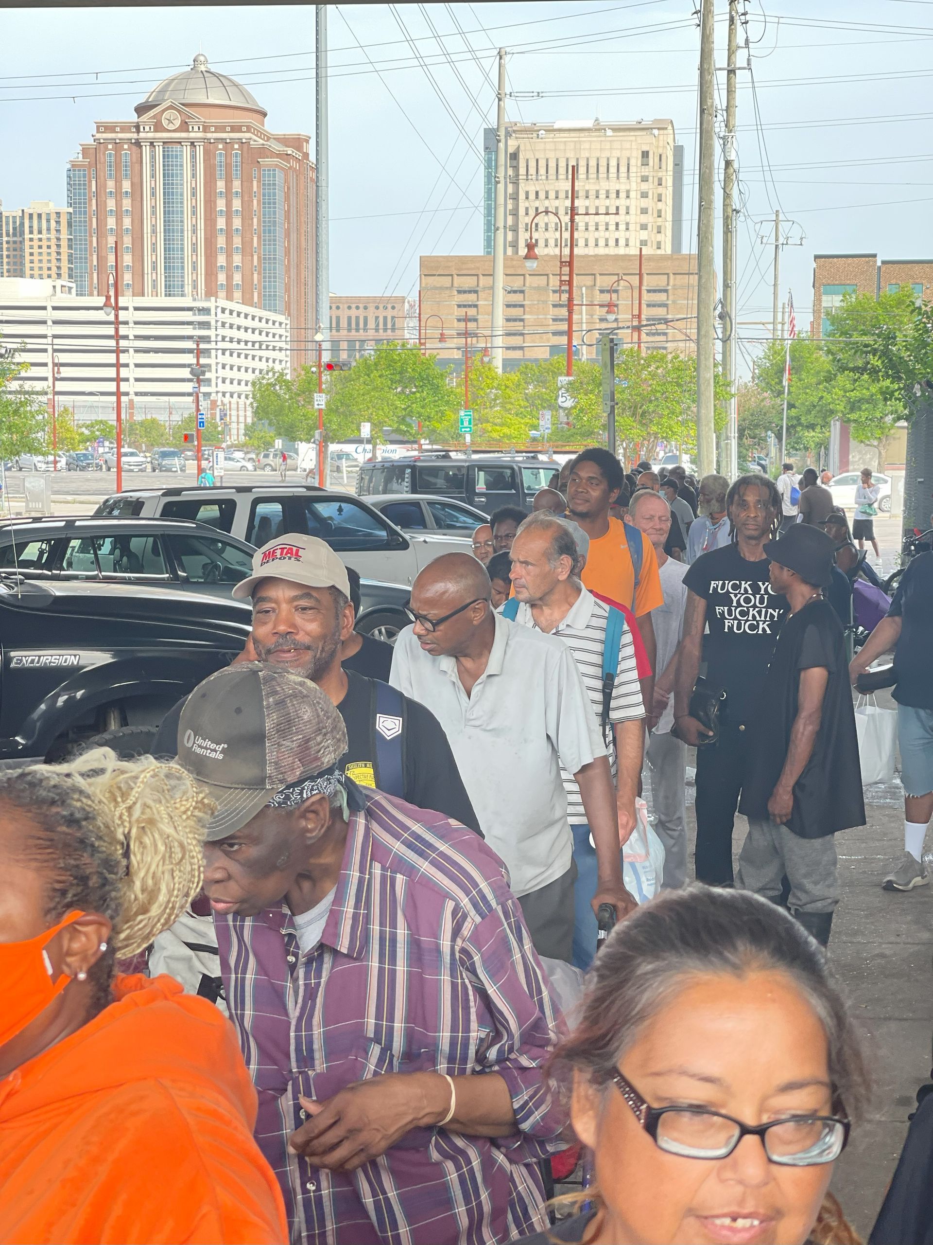 A crowd of people are gathered in a parking lot