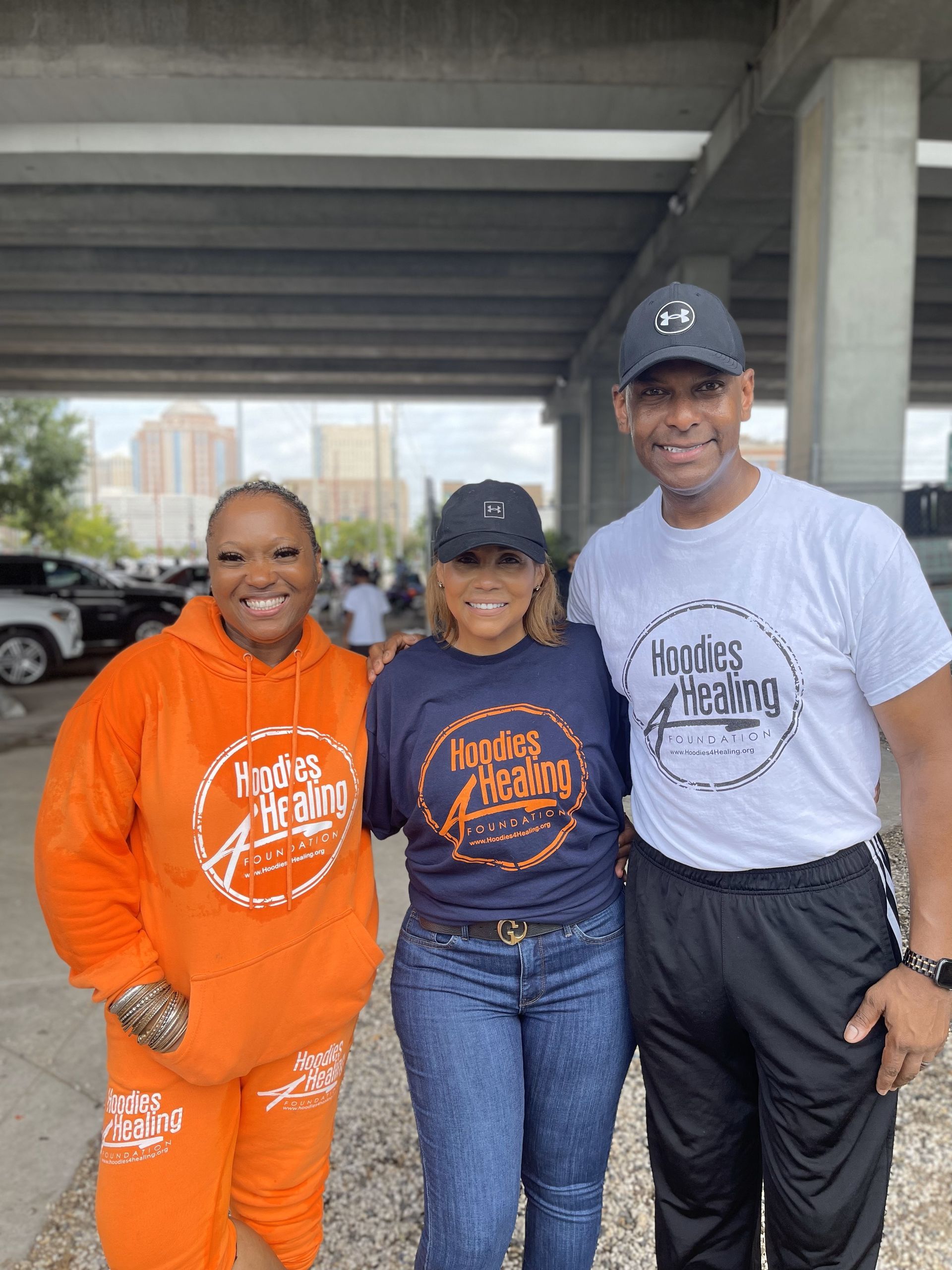 A group of people are posing for a picture in a parking lot.
