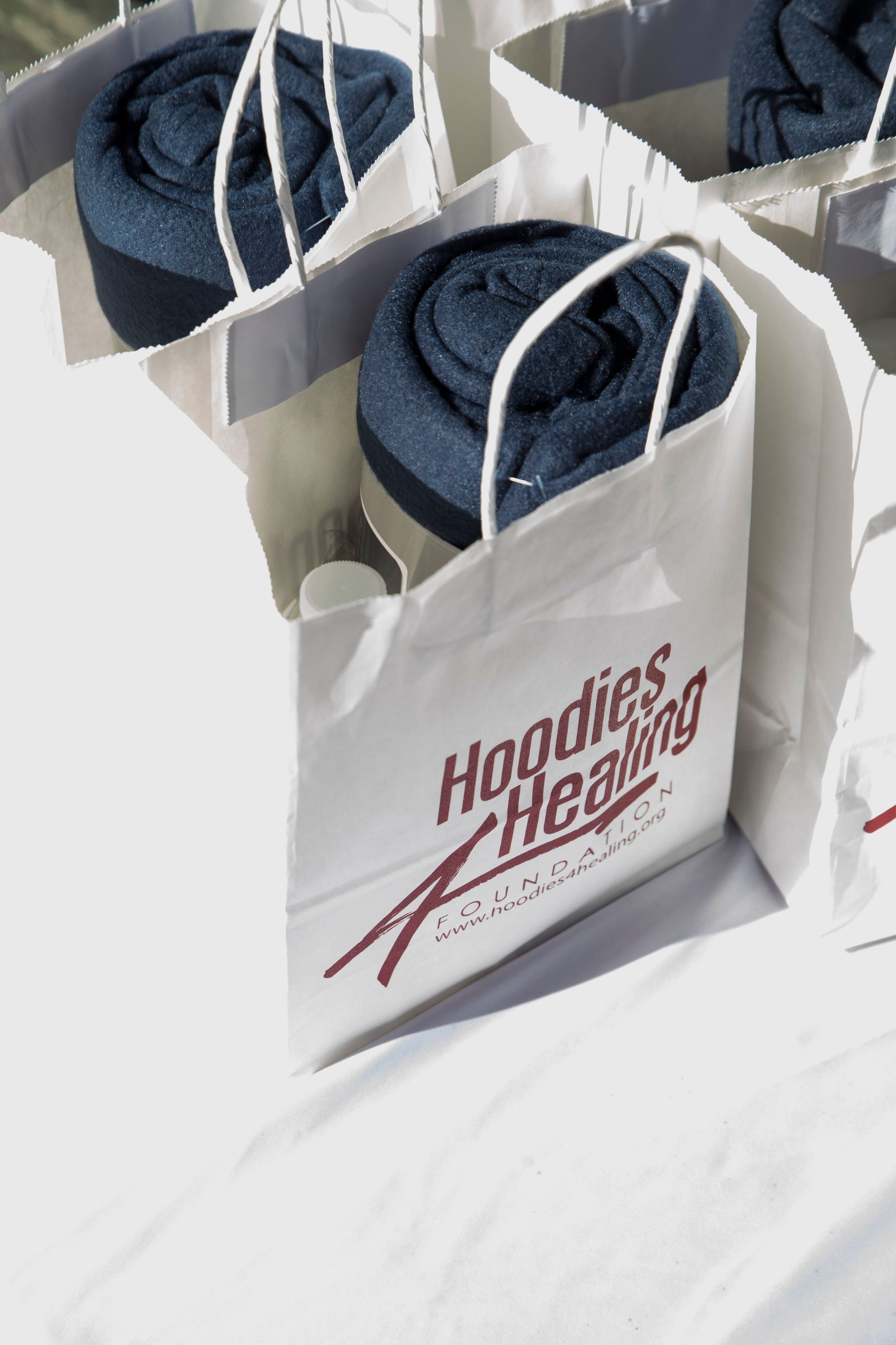 A white bag that says hoodies healing on it