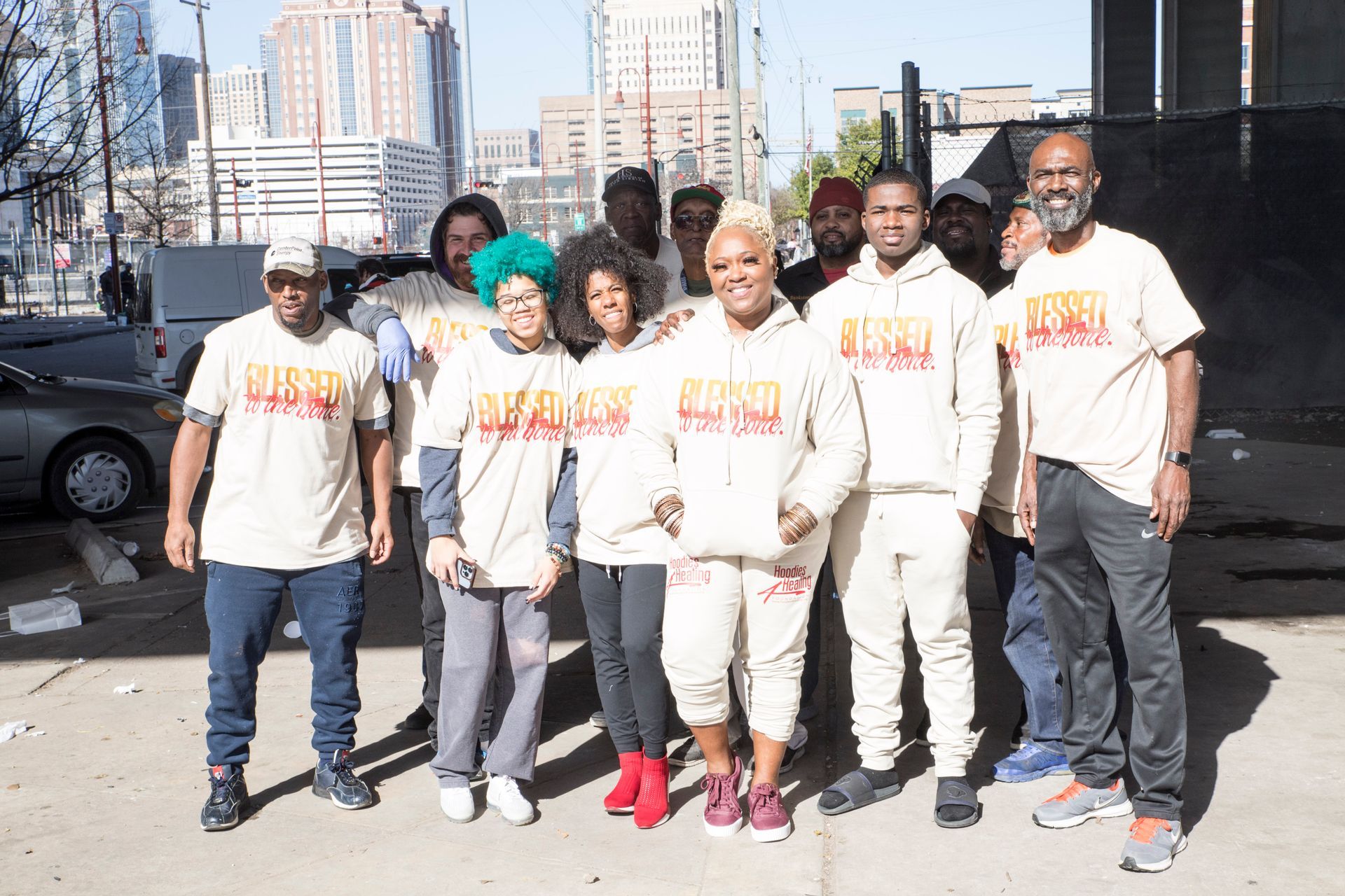 A group of people are posing for a picture in front of a city.