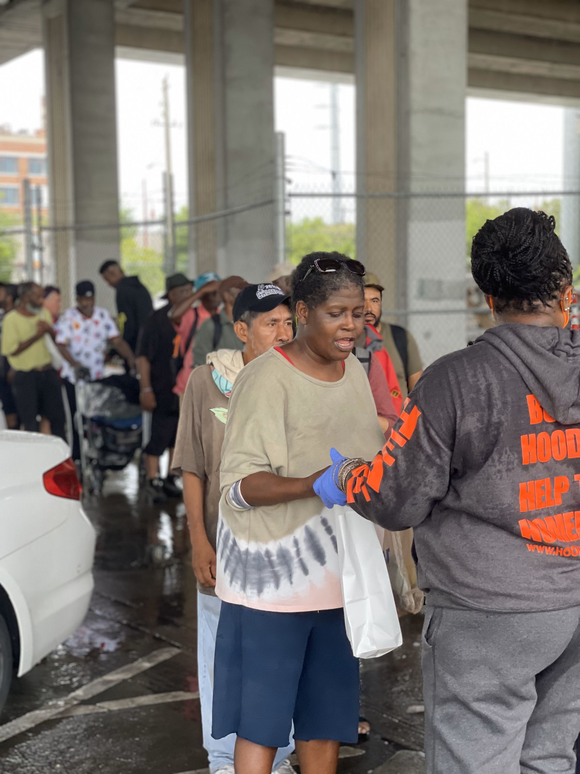 A group of people are standing in a parking lot.