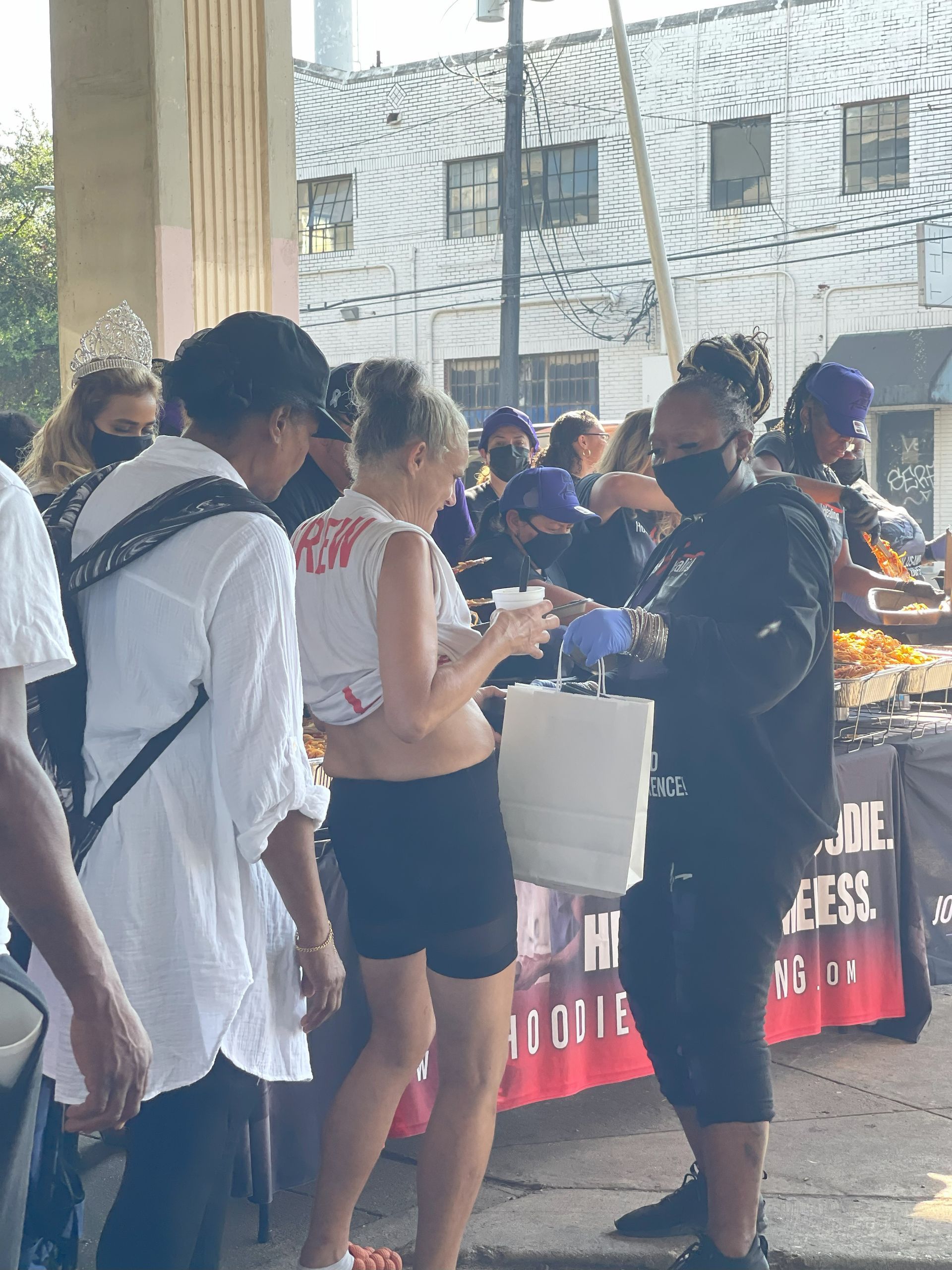 A group of people are standing around a table.