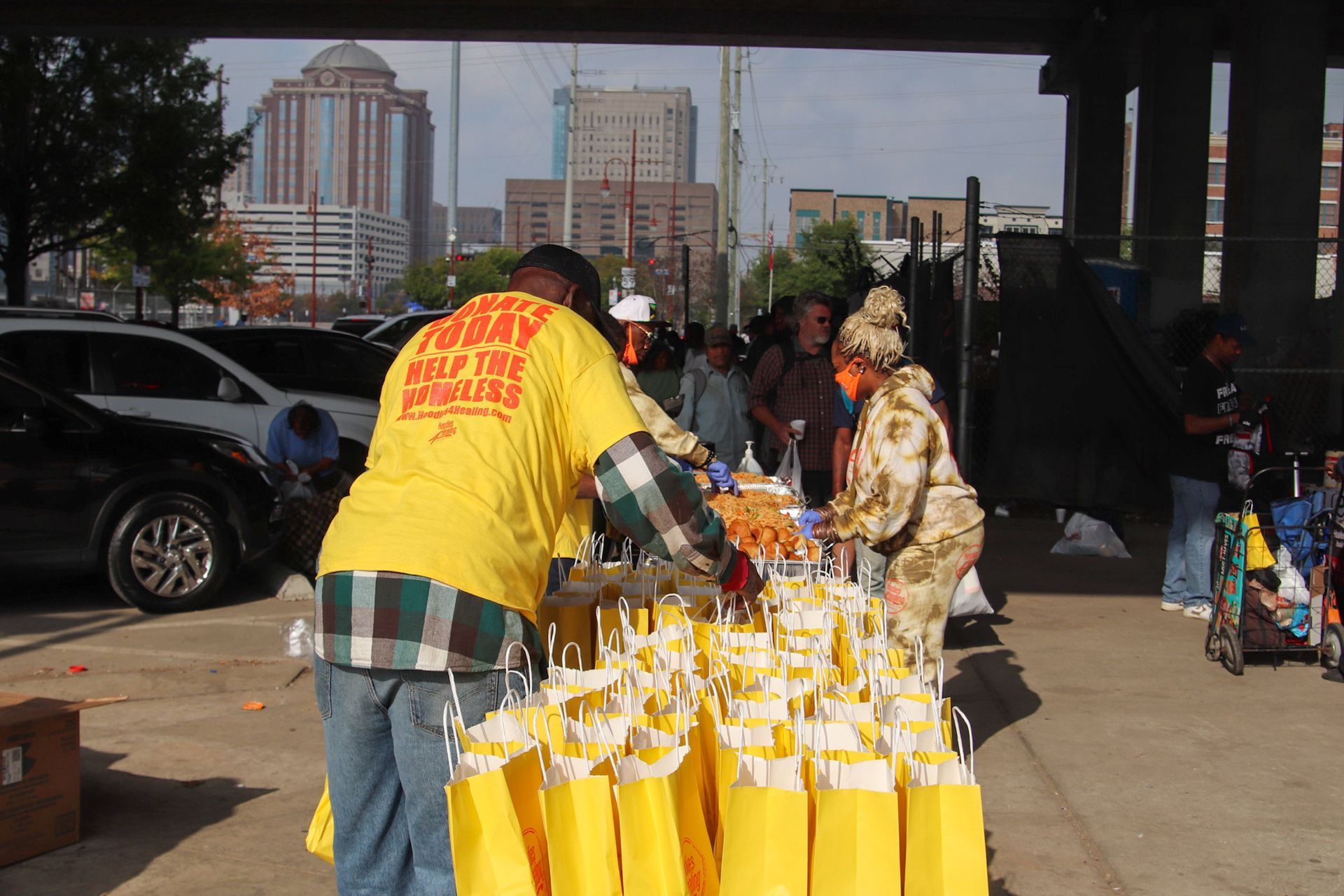 A man wearing a yellow shirt that says ' curry ' on it