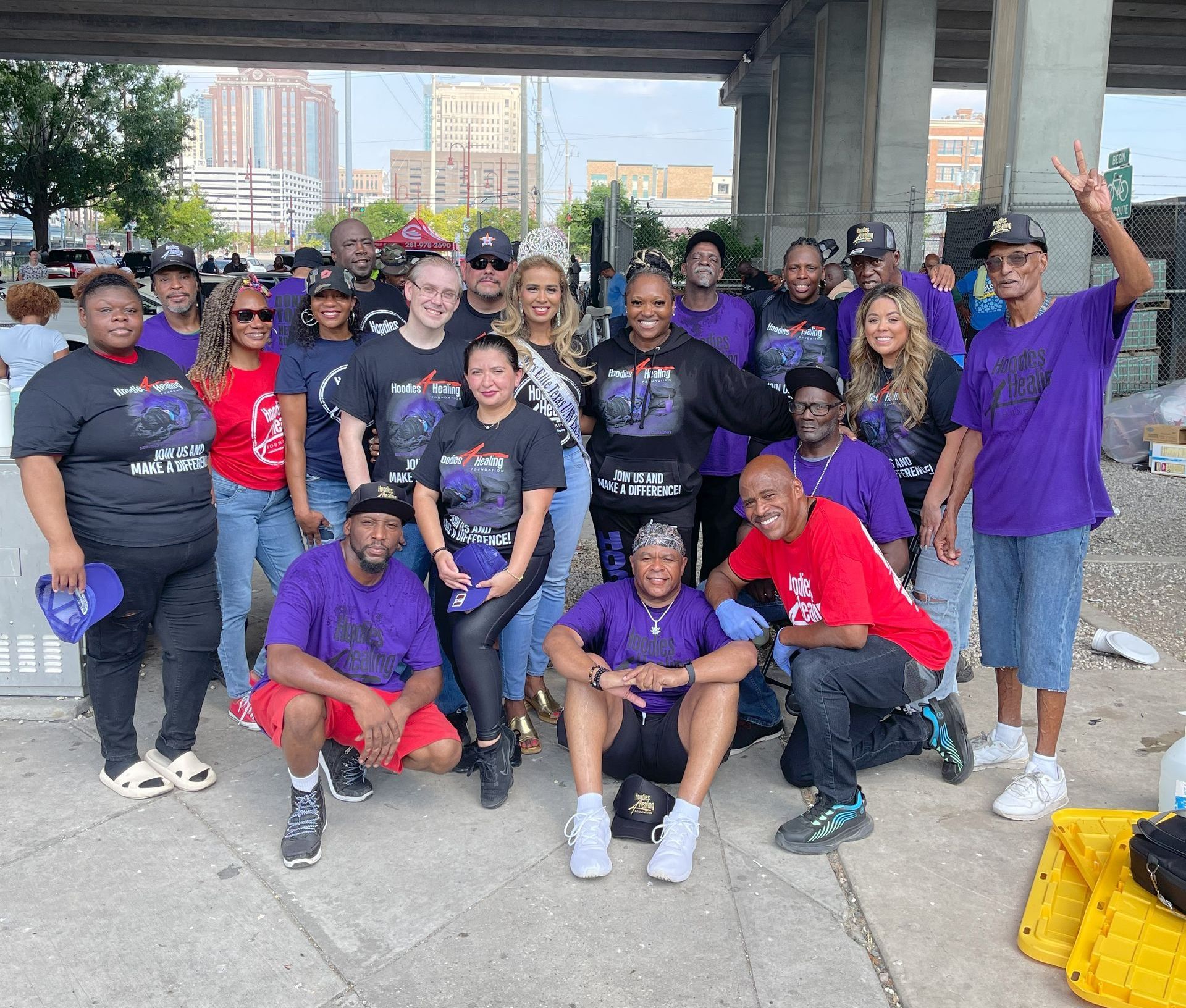 A group of people in purple shirts are posing for a picture.