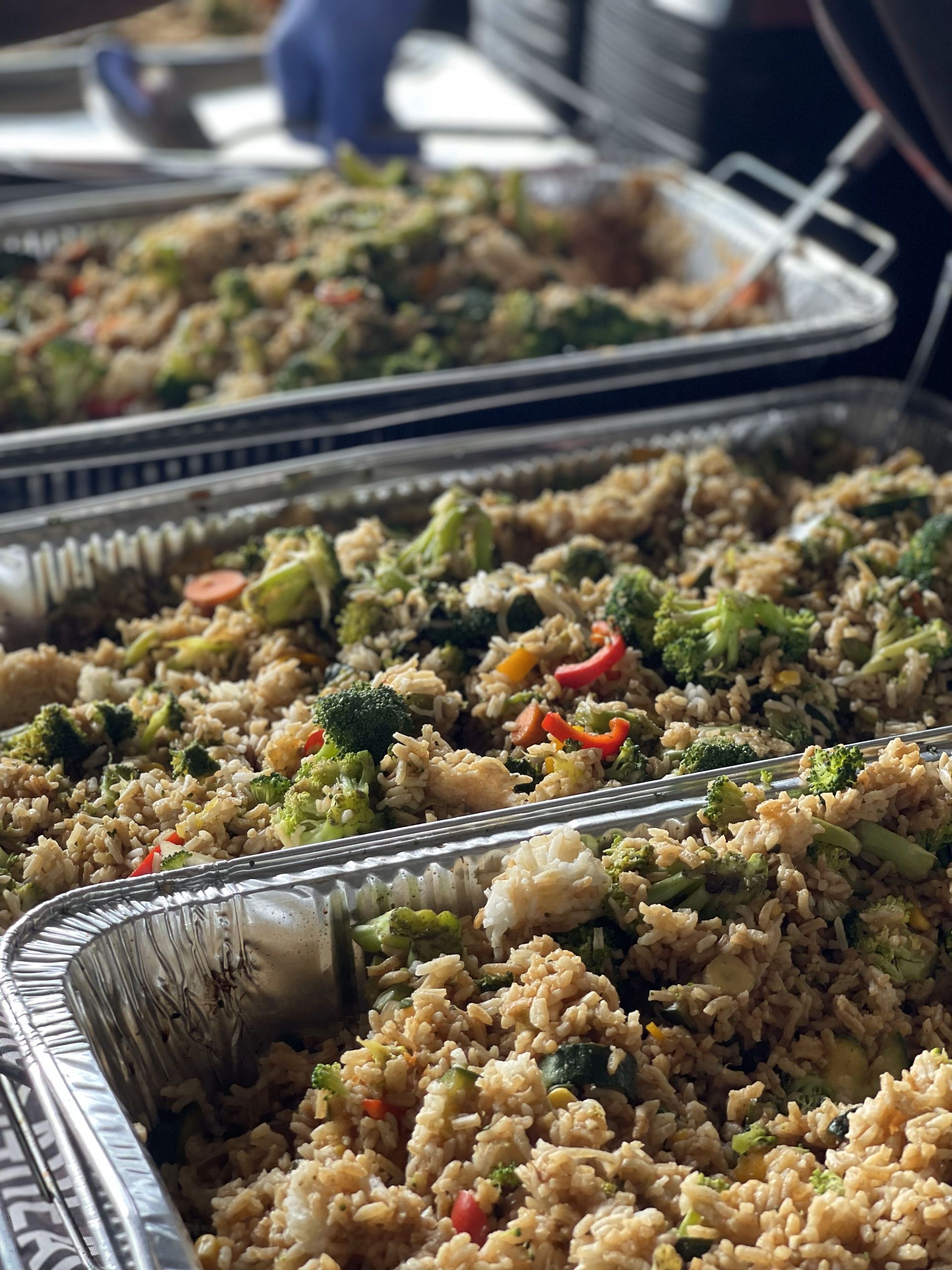 A close up of a tray of rice and vegetables.