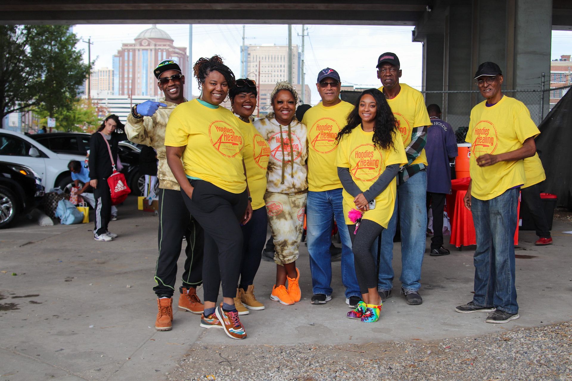 A group of people wearing yellow shirts are posing for a picture.