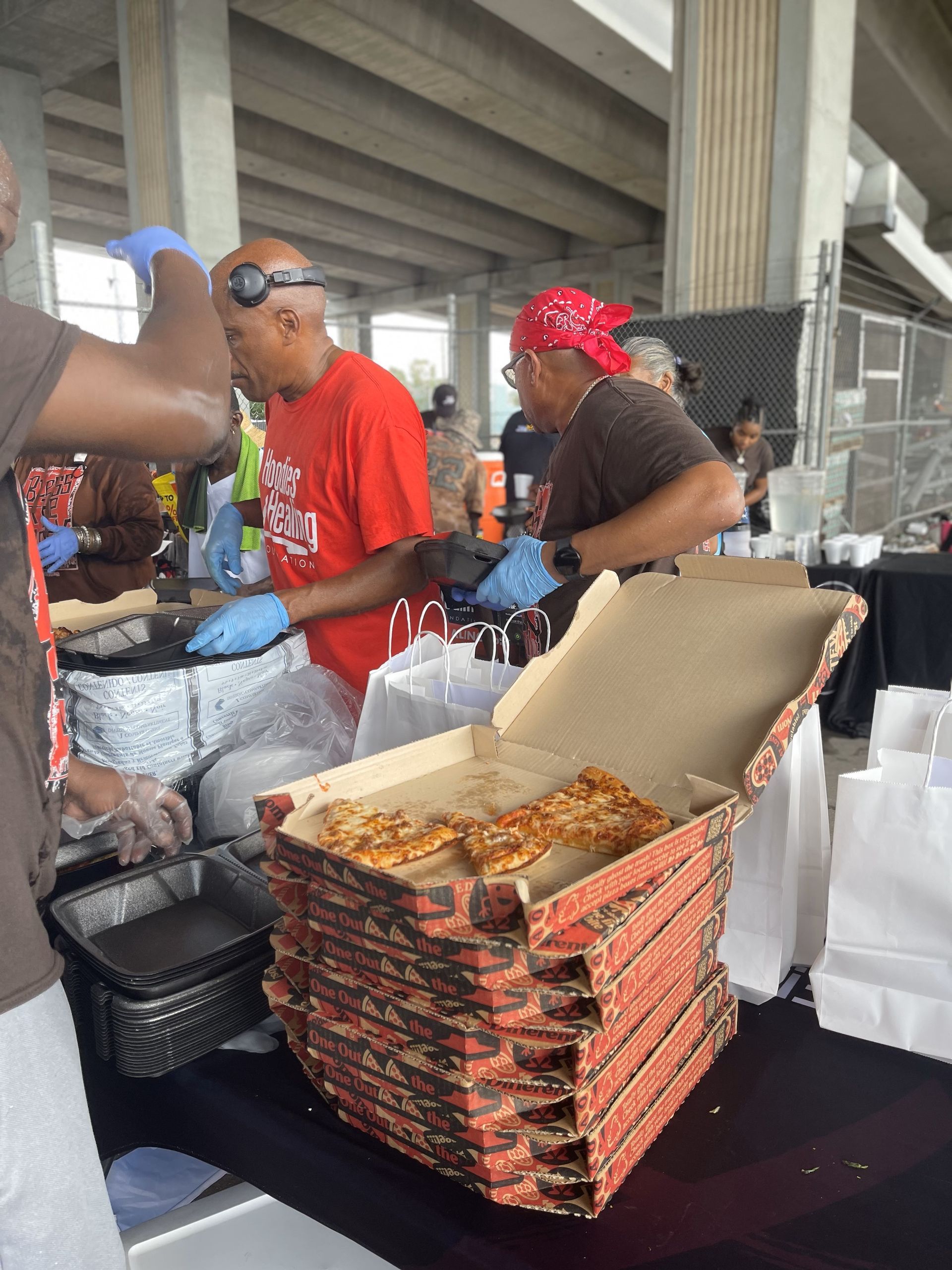 A stack of pizza boxes sitting on a table