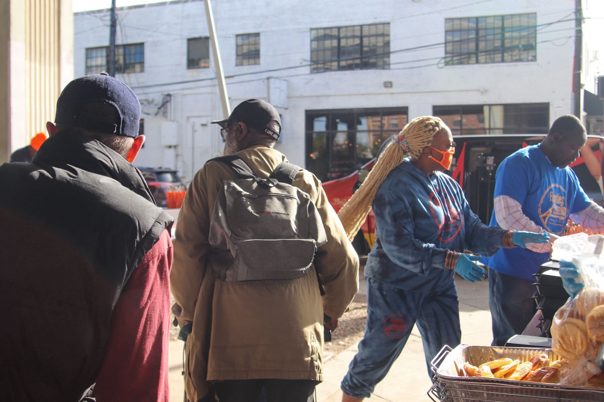 A group of people are standing in front of a building.