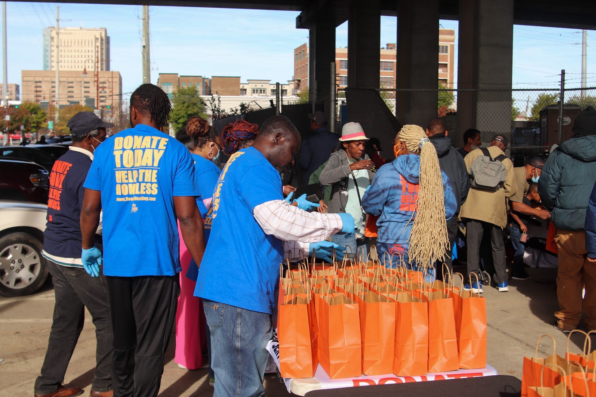 A group of people wearing blue shirts that say donate tony