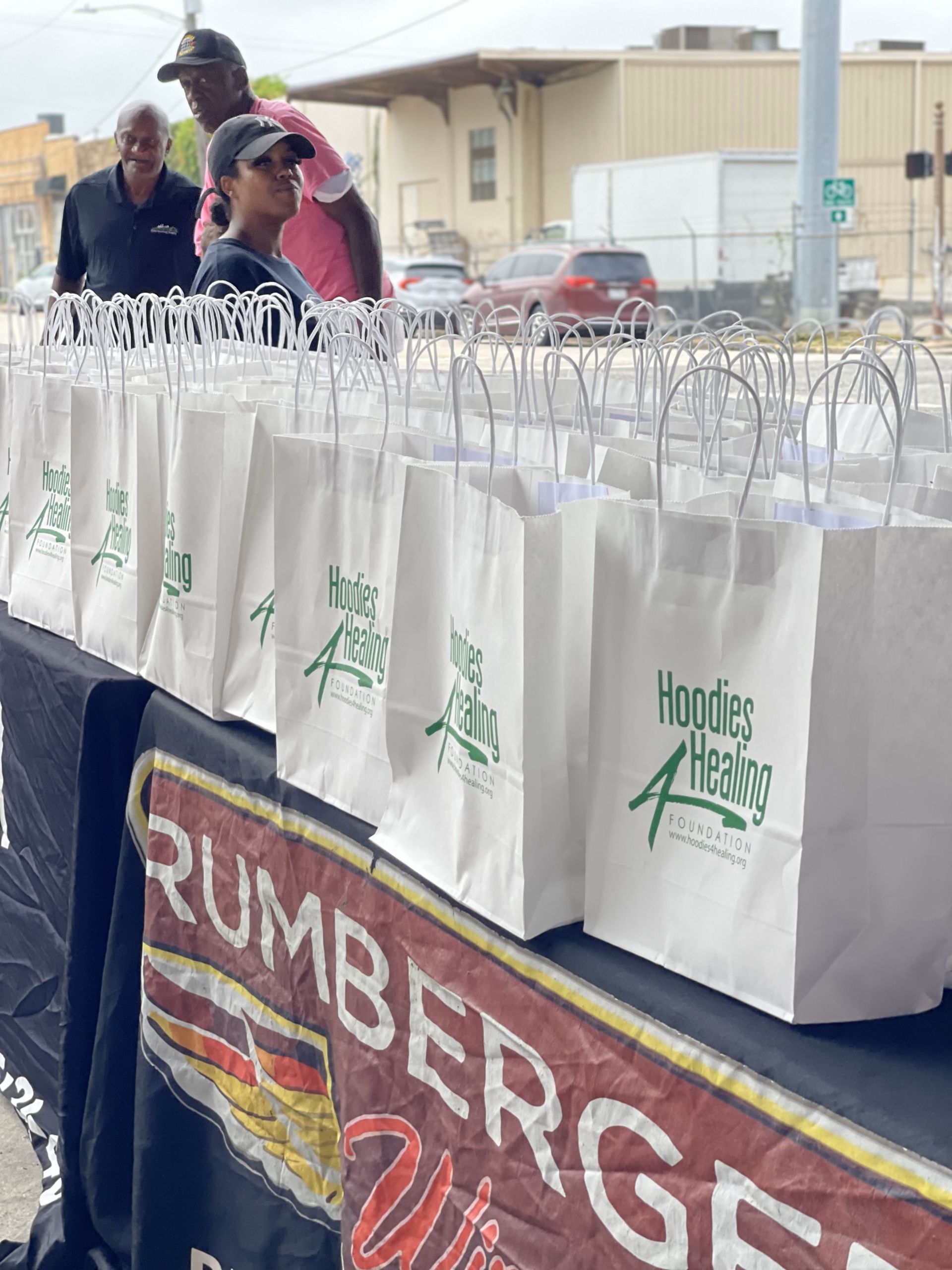A table with a lot of bags on it and a sign that says rumberger on it.